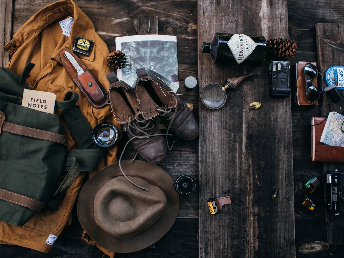 One-page packing checklist with a small backpack, water bottle and trail map laid out beside it